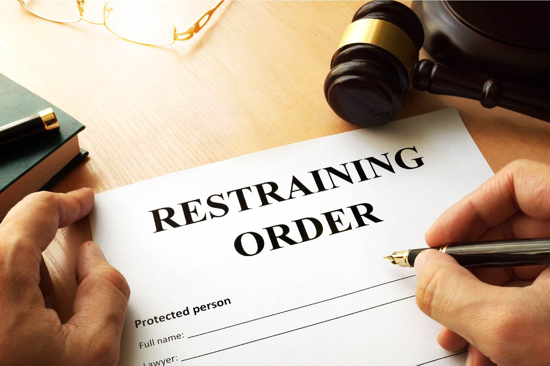 A lawyer filling out a restraining order form